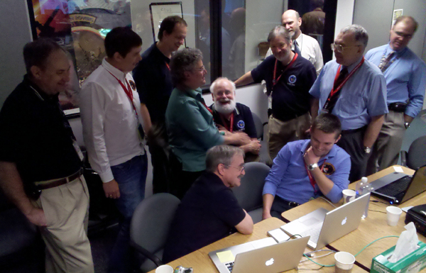 Scientists gather around Pete Schultz and his student Brendan to see their analysis