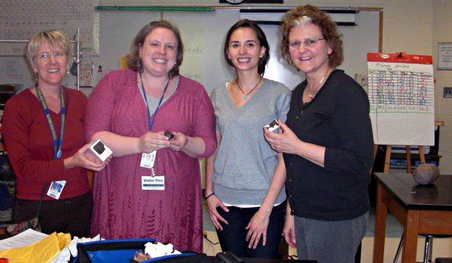 L to R: Polly Rouhan, Marylyn Salagaj, Carolyn Crow, Valorie Wright. Apparently holding a real space rock is much more exciting than holding a model of one (3-D model of the nucleus of Tempel 1 sits on the table in the background)!