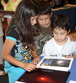 Young guests visit the EPOXI booth to learn about comets.