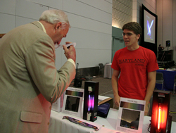 UM President Mote visits the Astro Department's booth.