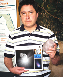 Visitor to Ft Lauderdale Museum of Discovery and Science holding a Comet Litho and 3D model of Tempel 1.
