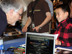 Don Sweetnam, Deputy Project Manager, uses the JPL Mission Simulation interactive to show visitors what to expect on encounter day.