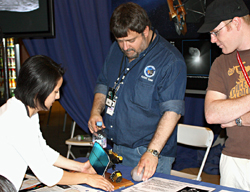 Greg LaBorde describes how the spacecraft was used on the original Deep Impact mission as <Rich Rieber (right) looks on.