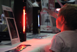 Children looking at glowing gas tubes with diffraction grating glasses.